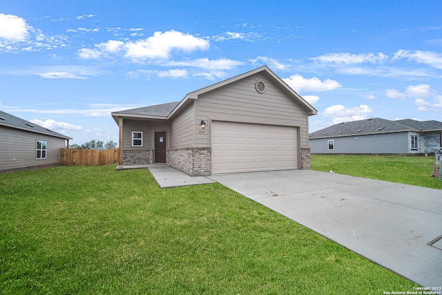 ranch-style house featuring a front yard and a garage