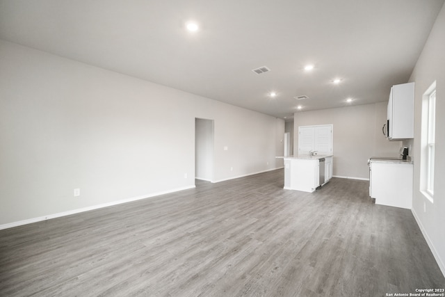 unfurnished living room featuring dark hardwood / wood-style flooring