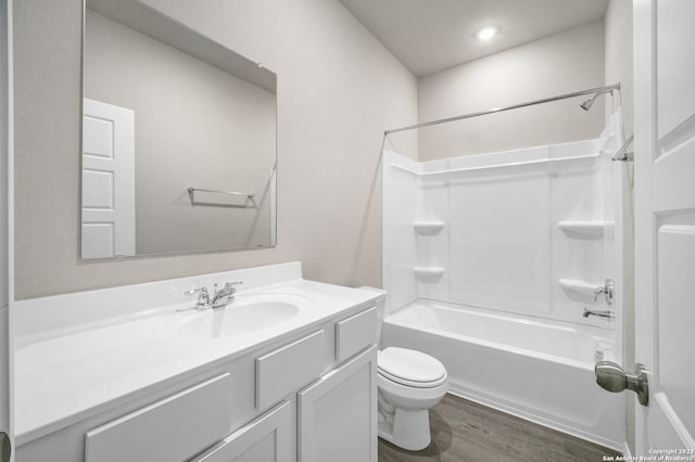 full bathroom featuring vanity, bathtub / shower combination, toilet, and hardwood / wood-style flooring