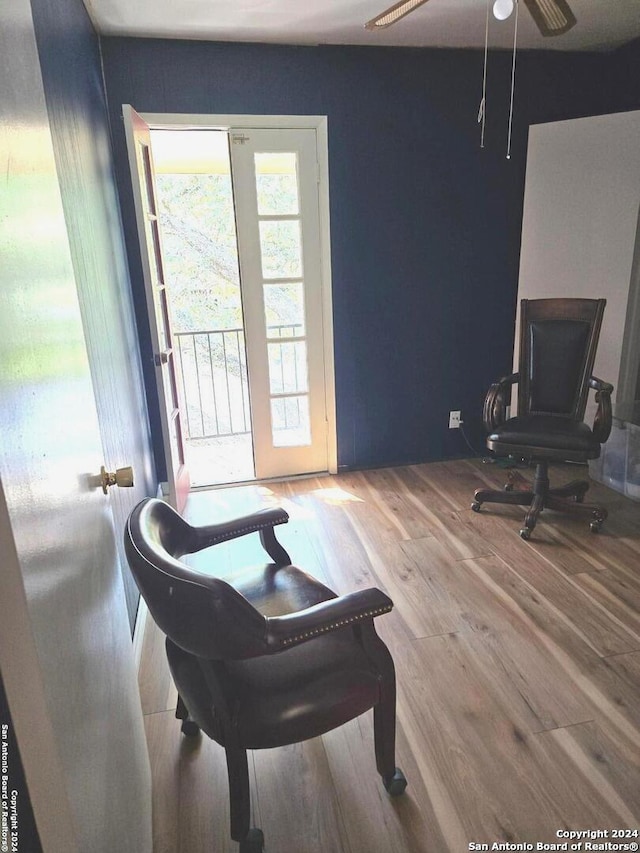 interior space with ceiling fan and wood-type flooring