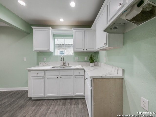 kitchen featuring light hardwood / wood-style floors, sink, and white cabinetry