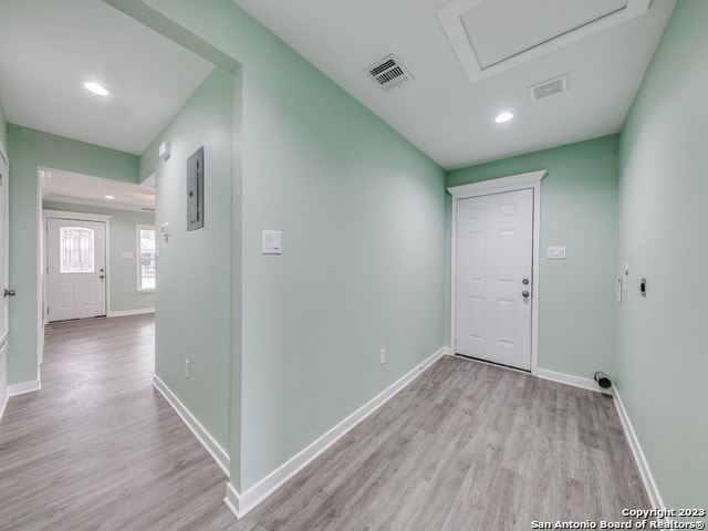 hallway featuring light hardwood / wood-style flooring and electric panel