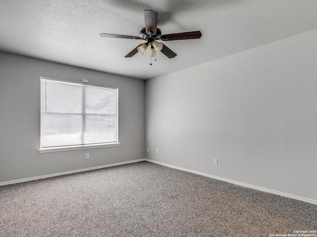 spare room featuring carpet floors, a textured ceiling, and ceiling fan