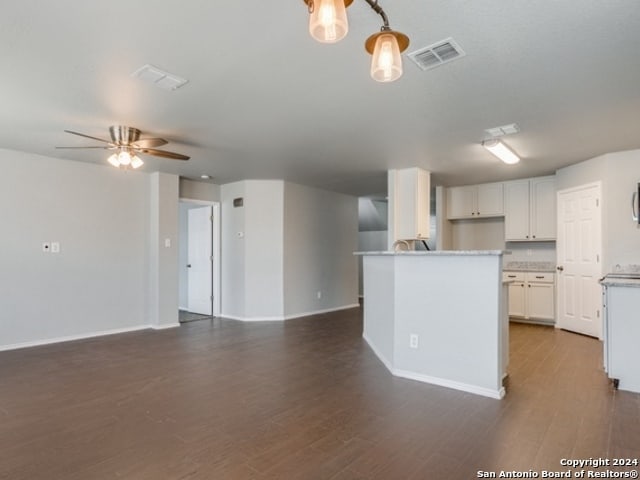 kitchen featuring white cabinetry, ceiling fan, and dark hardwood / wood-style floors