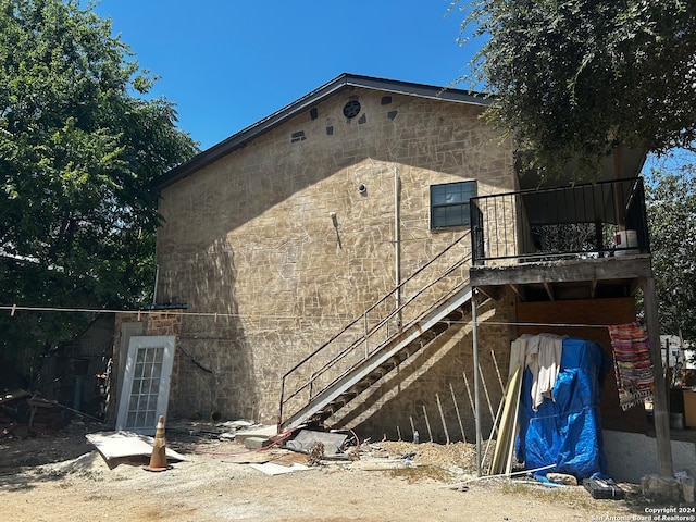 view of side of home with a balcony