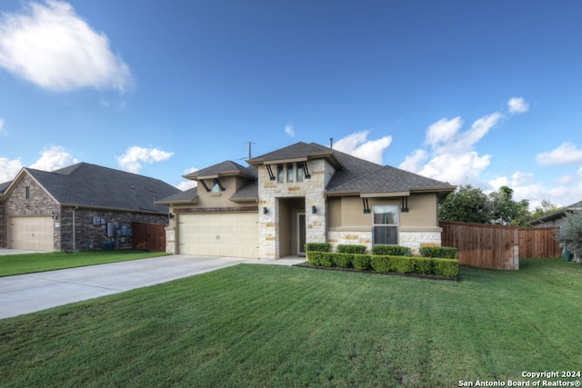 view of front of property with a front yard and a garage