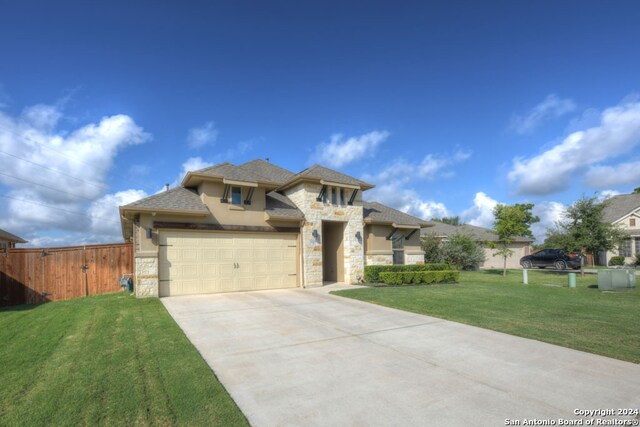 view of front of property featuring a front lawn and a garage