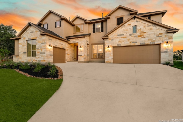 view of front of property featuring a lawn and a garage