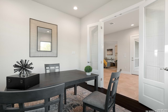 home office with french doors and hardwood / wood-style floors