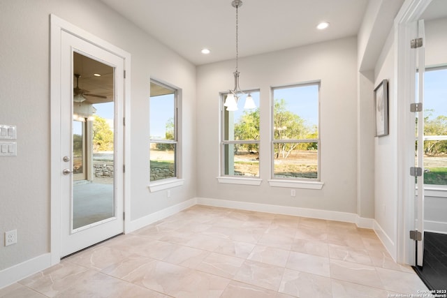 unfurnished dining area with a chandelier