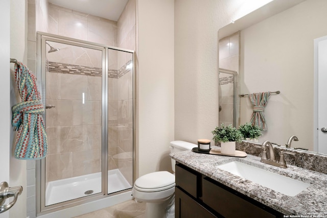 bathroom with vanity, walk in shower, and toilet