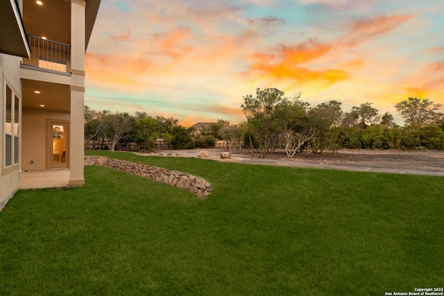 yard at dusk with a balcony