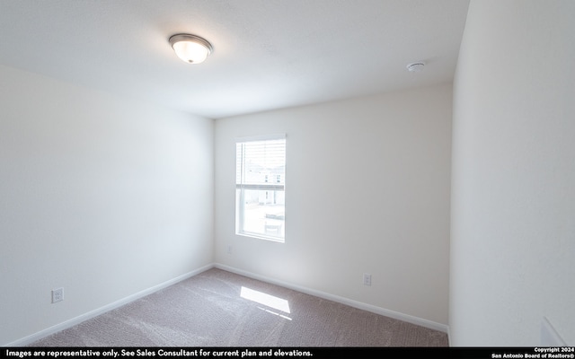 spare room featuring carpet floors