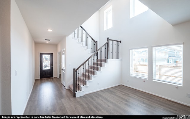 foyer with light hardwood / wood-style flooring and a high ceiling