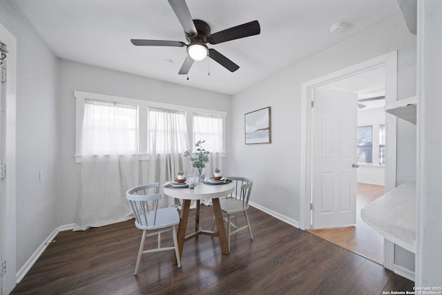 dining room with dark hardwood / wood-style flooring and ceiling fan