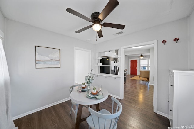 dining space with dark hardwood / wood-style flooring