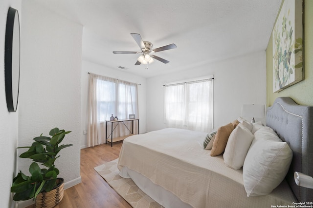 bedroom featuring hardwood / wood-style flooring and ceiling fan