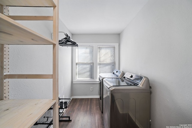 clothes washing area featuring washer and clothes dryer and dark hardwood / wood-style floors