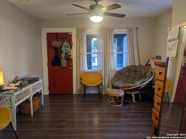 sitting room featuring dark hardwood / wood-style flooring and ceiling fan