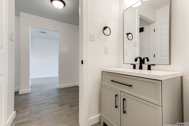 bathroom with wood-type flooring and vanity