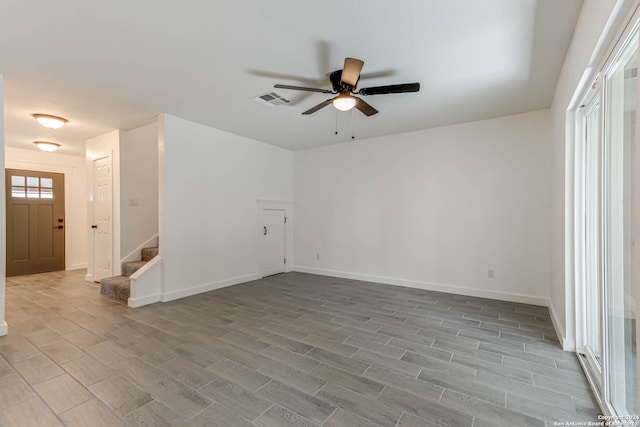 empty room featuring light wood-type flooring and ceiling fan