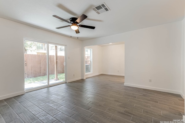 spare room with ceiling fan and dark hardwood / wood-style floors