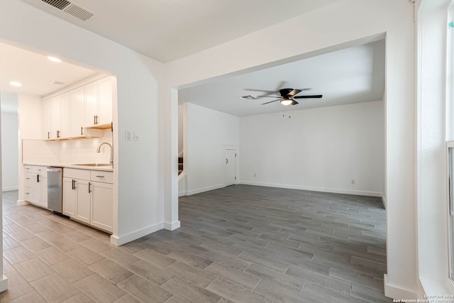 unfurnished living room featuring ceiling fan, light wood-type flooring, and sink