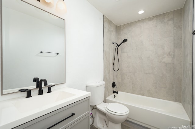 full bathroom featuring vanity, toilet, and tiled shower / bath