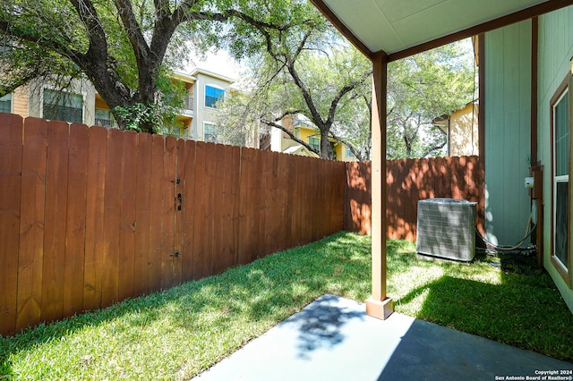 view of yard with cooling unit and a patio area