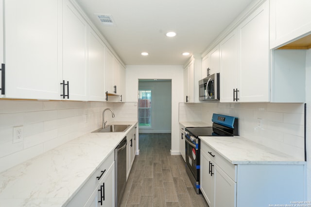 kitchen featuring light wood-type flooring, white cabinetry, sink, and stainless steel appliances