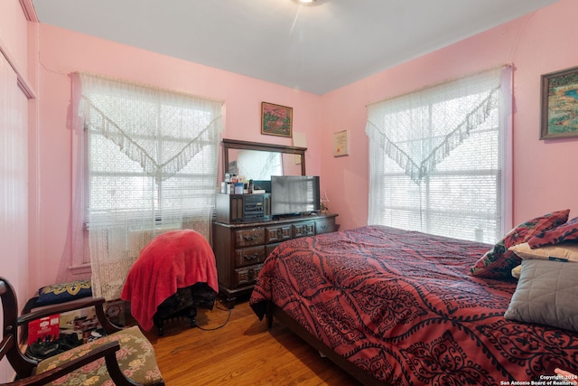 bedroom featuring hardwood / wood-style flooring and multiple windows