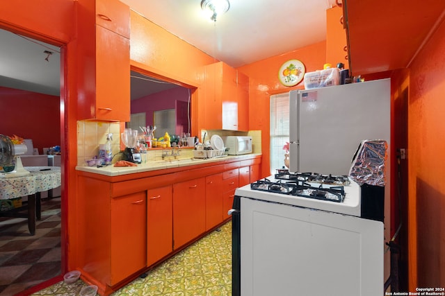 kitchen featuring white appliances and decorative backsplash