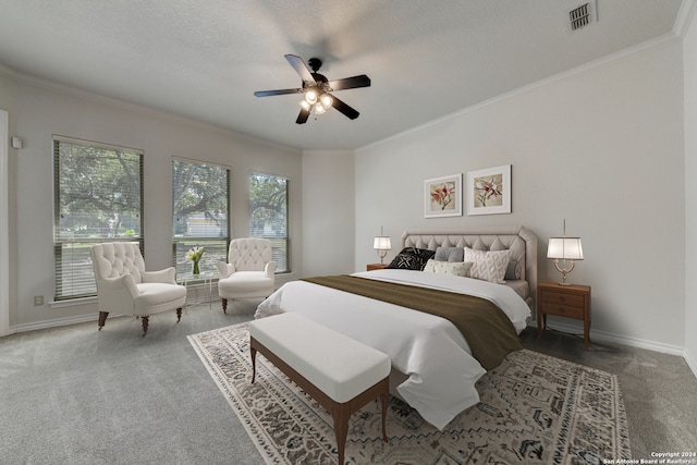 carpeted bedroom featuring a textured ceiling, crown molding, and ceiling fan