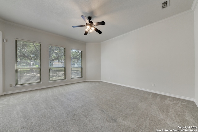 unfurnished room with light carpet, a wealth of natural light, ceiling fan, and crown molding