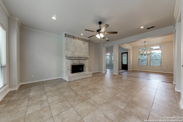 unfurnished living room featuring ceiling fan with notable chandelier, light tile patterned floors, a fireplace, and crown molding