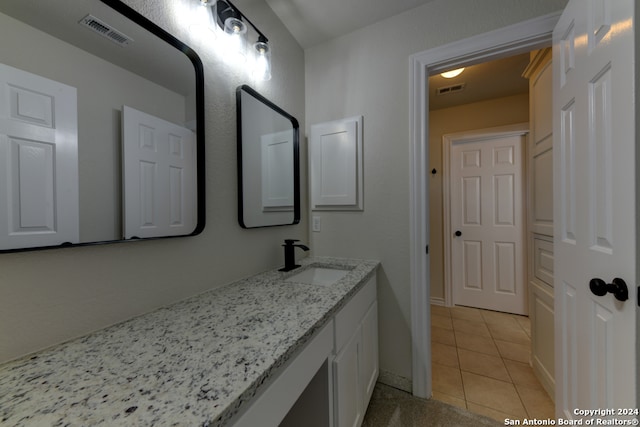 bathroom featuring tile patterned flooring and vanity