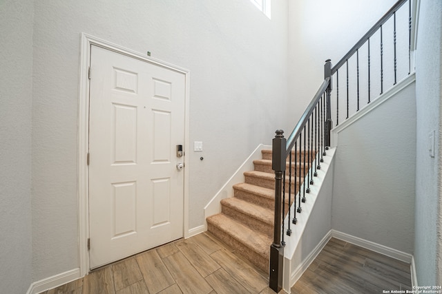 stairway featuring hardwood / wood-style floors