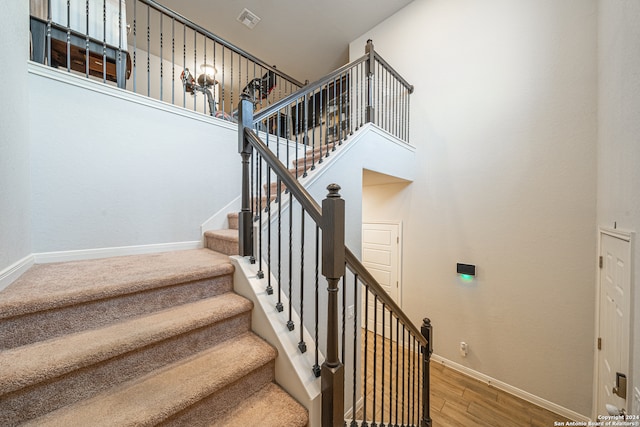 staircase with hardwood / wood-style floors