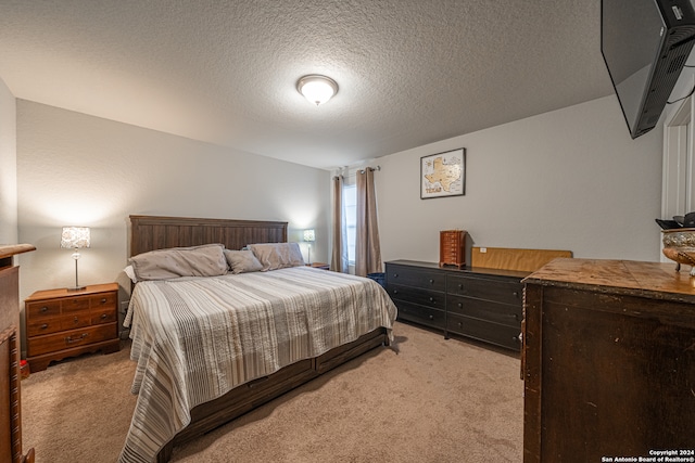 bedroom with a textured ceiling, lofted ceiling, and light carpet