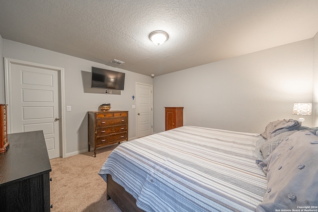 carpeted bedroom with a textured ceiling