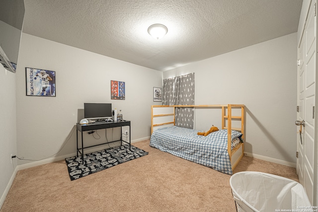 bedroom featuring light colored carpet and a textured ceiling