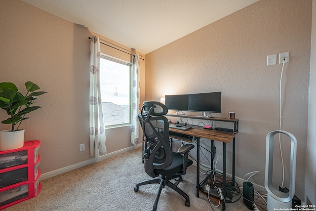 carpeted office with lofted ceiling