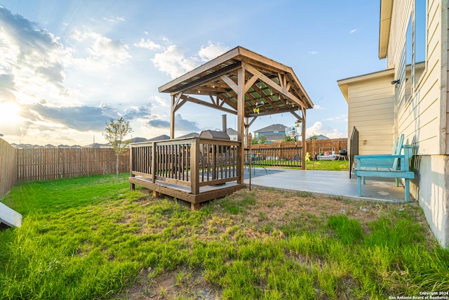 view of yard featuring a gazebo, a wooden deck, and a patio area