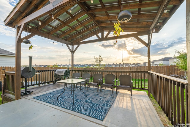 deck at dusk with a gazebo and grilling area