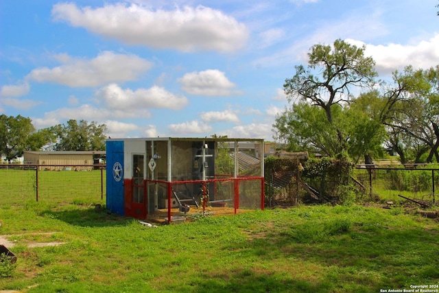 exterior space with a yard and an outbuilding