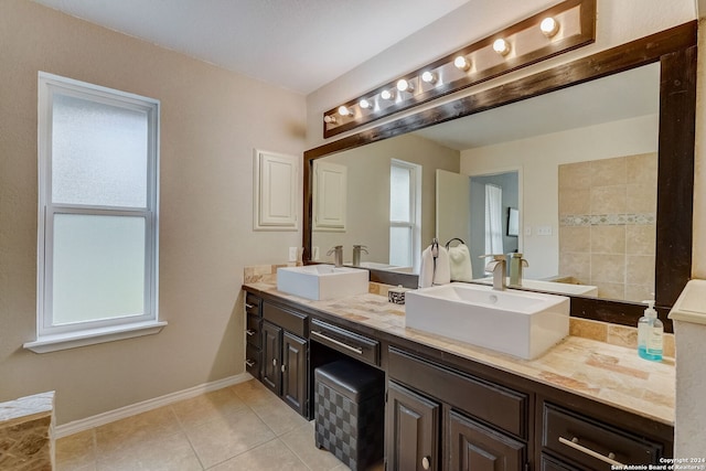 bathroom featuring tile patterned flooring, vanity, and a wealth of natural light