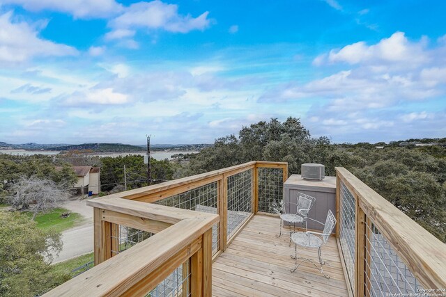 wooden deck featuring a water view