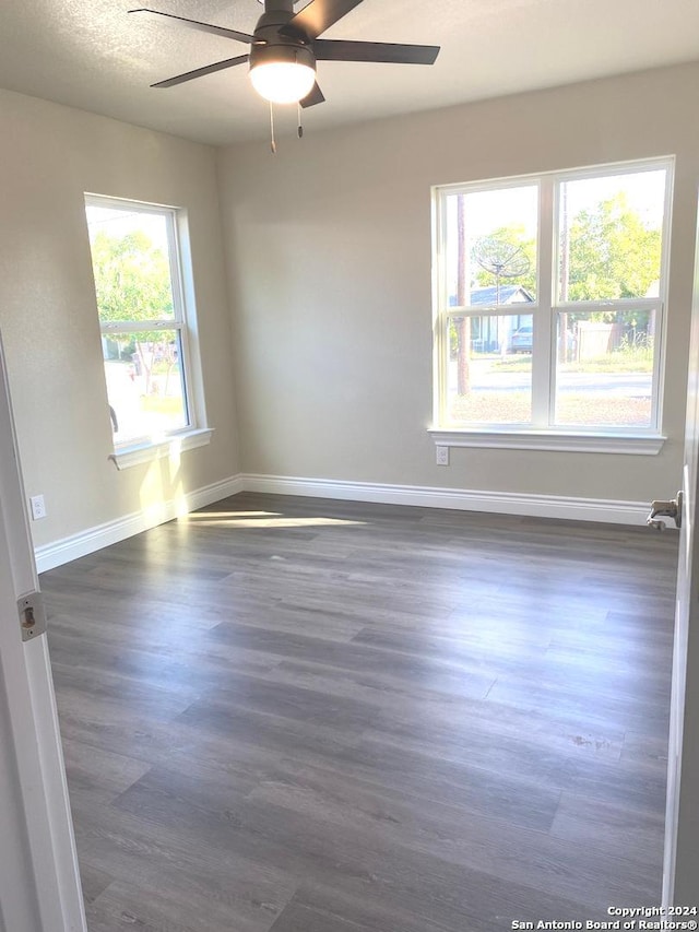 spare room featuring ceiling fan, a textured ceiling, and dark hardwood / wood-style flooring