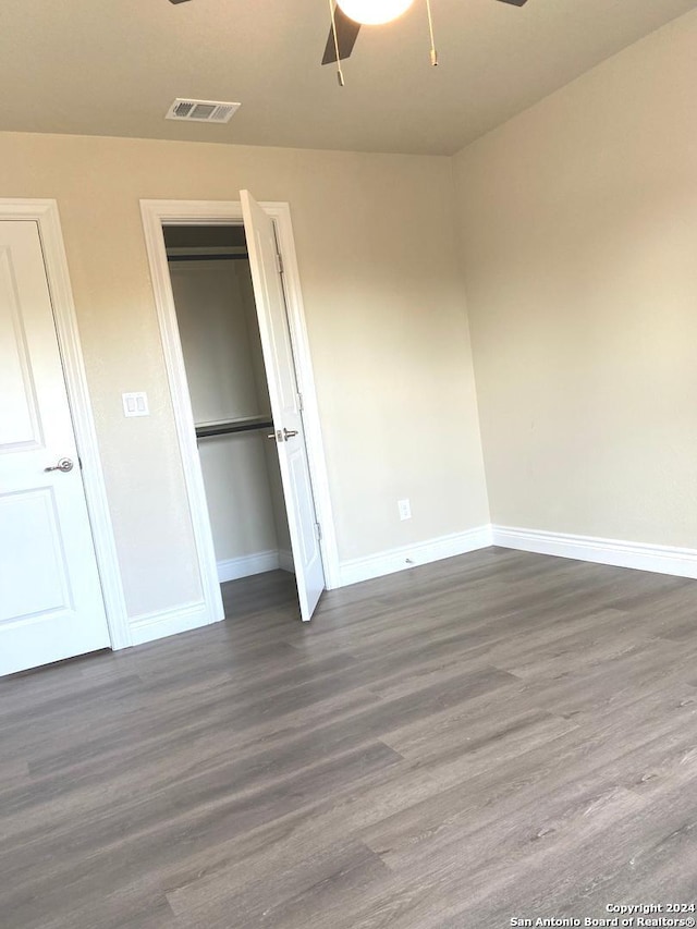 unfurnished bedroom featuring hardwood / wood-style floors and ceiling fan