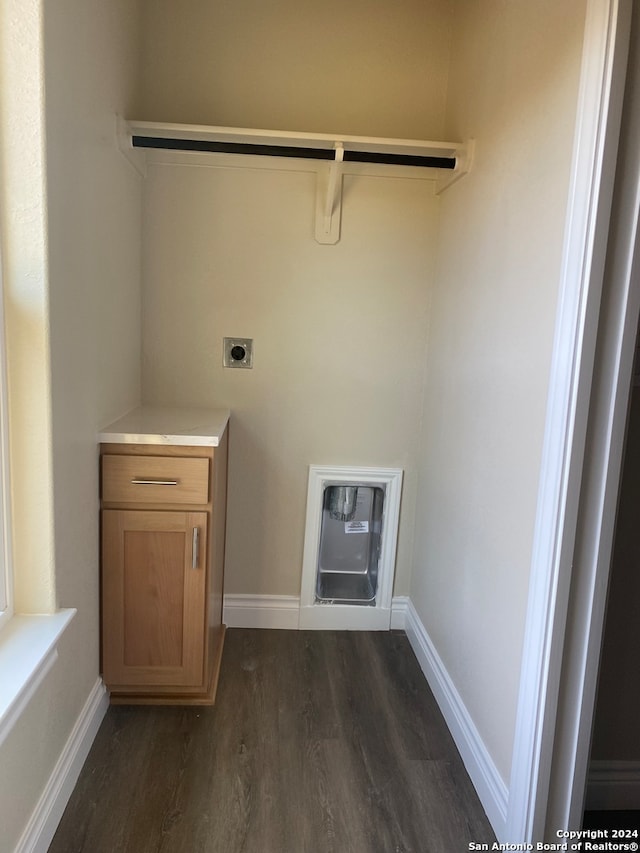 laundry area with electric dryer hookup, heating unit, and dark hardwood / wood-style floors